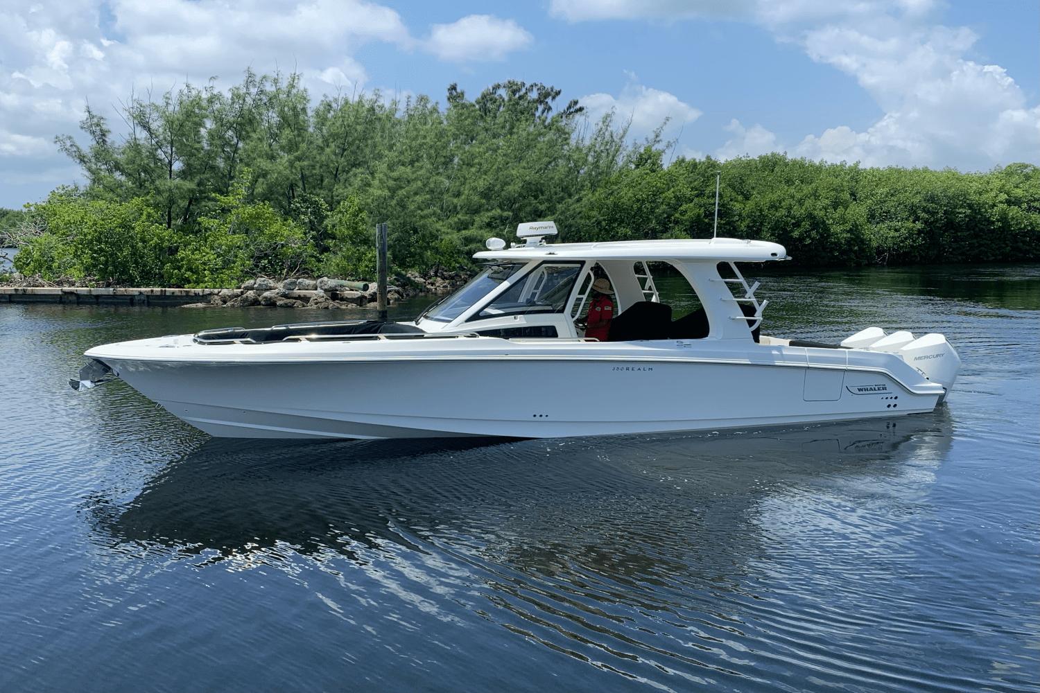 Boston Whaler 350 Realm 2022 Boston Whaler 350 Realm boat on calm water, surrounded by lush greenery.