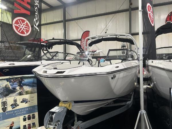 Yamaha Boats 252S 2025 Yamaha Boats 252S on display in a showroom with promotional banners.