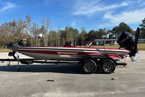 Phoenix 721 ZXL 2026 Phoenix 721 ZXL bass boat on trailer, red and white design, parked outdoors.