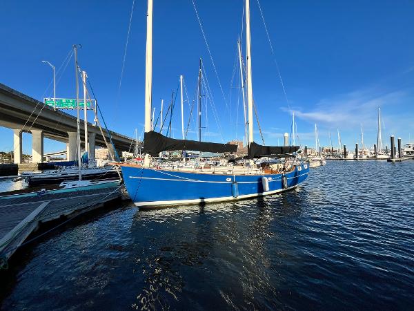 Freedom 40 Cat-Ketch 1979 Freedom 40 Cat-Ketch sailboat docked in a marina under clear blue skies.