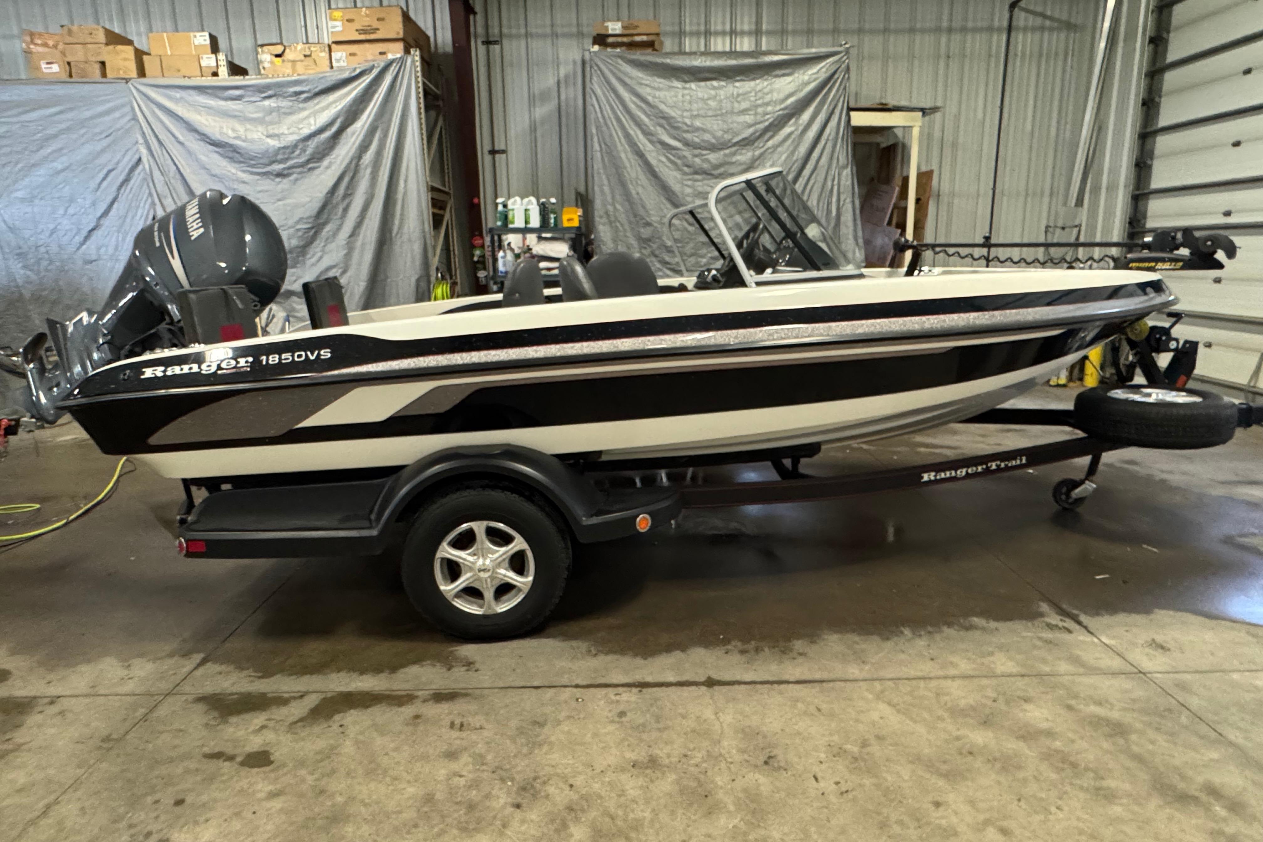 Ranger 1850 Reata 2008 Ranger 1850 Reata boat in a garage, featuring a Yamaha motor and trailer.