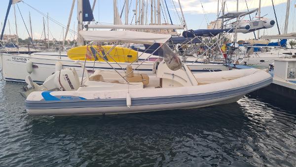 Joker Boat 700 WIDE 2012 Joker Boat 700 WIDE moored in marina, surrounded by sailboats.