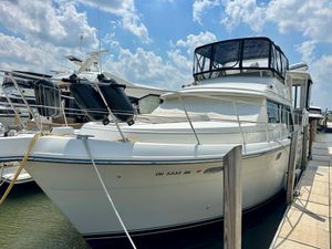 Carver 440 Aft Cabin Motor Yacht 1995 Carver 440 Aft Cabin Motor Yacht docked under a partly cloudy sky.