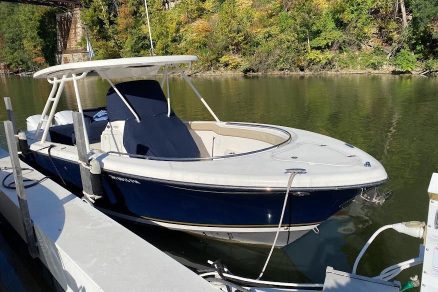Pursuit S 280 Sport 2015 Pursuit S 280 Sport boat docked on a calm river.