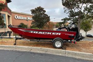 Tracker Super Guide V-16 T 2026 Tracker Super Guide V-16 T boat parked outside Outdoor World store.