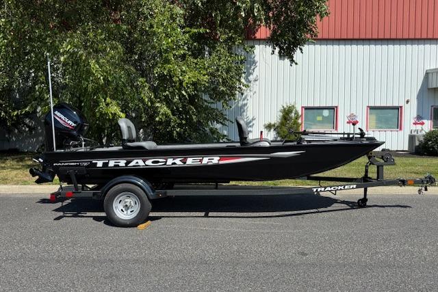 Tracker Panfish 17 2026 Tracker Panfish 17 boat on trailer, parked outdoors near building.
