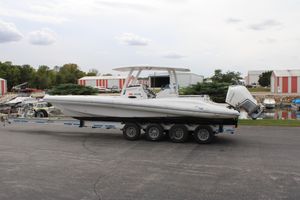 Airship 340 2019 Airship 340 boat on trailer, parked near marina with storage buildings.