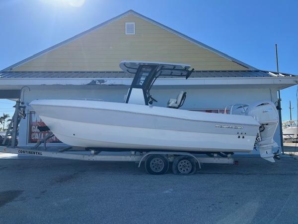 World Cat 235 TE 2025 World Cat 235 TE boat on trailer, parked outside a yellow building.