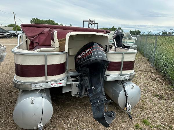 Premier ALANTE 1996 Premier ALANTE pontoon boat with Mercury outboard motor, parked on gravel.