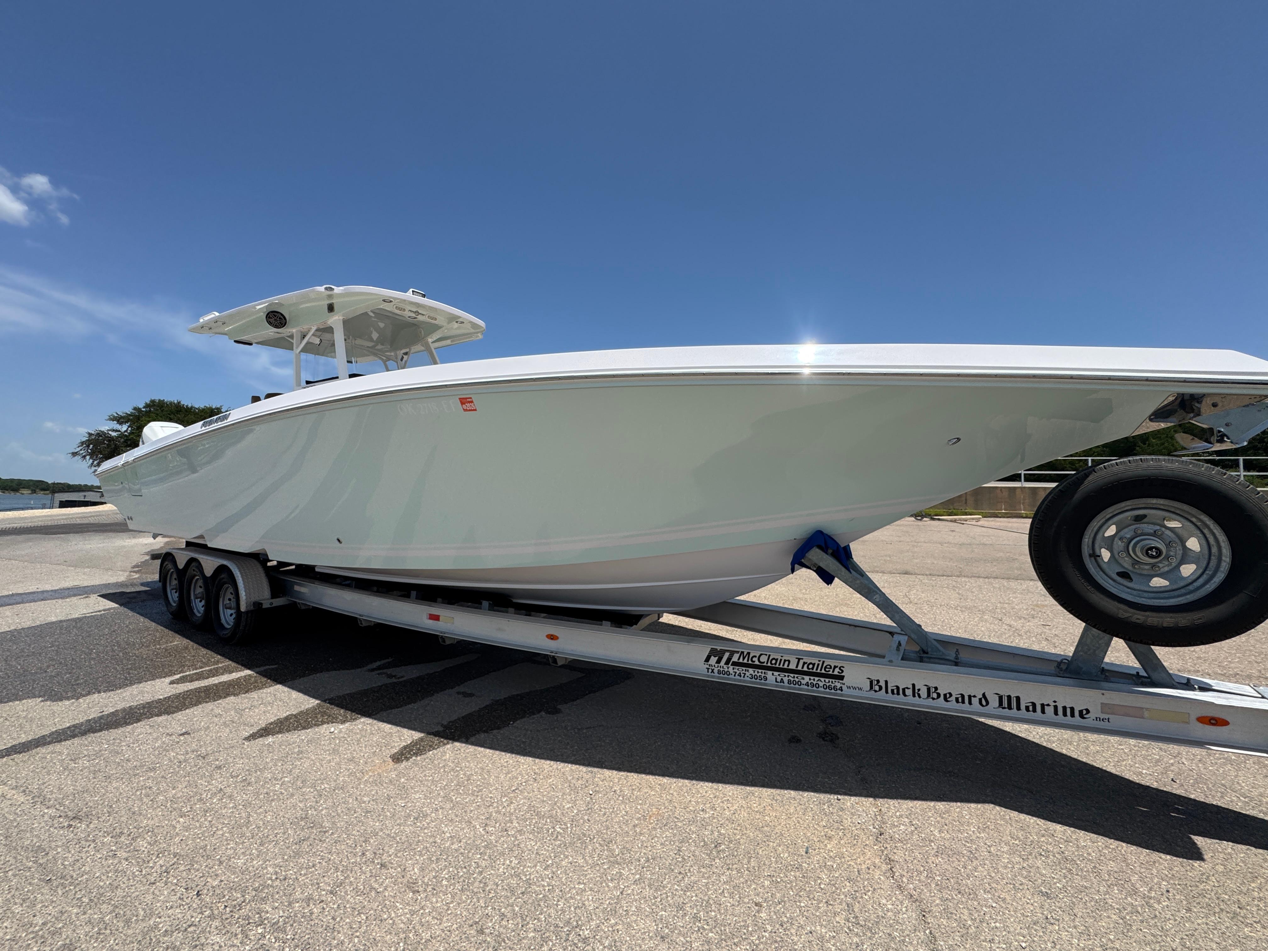 Fountain 38 CC 2018 Fountain 38 CC boat on trailer under clear blue sky.