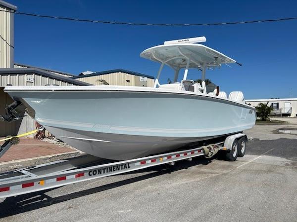 Jupiter 30 2025 Jupiter 30 boat on trailer, parked outdoors under clear blue sky.