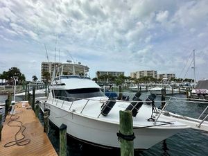 Hatteras 46 Convertible 1994 Hatteras 46 Convertible yacht docked at marina under cloudy sky.