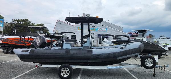 Zodiac Milpro 2100 LE 2011 Zodiac Milpro 2100 LE boat on trailer, parked in a marina lot.