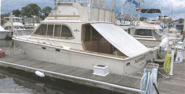 Egg Harbor 33 Convertible 1983 Egg Harbor 33 Convertible boat docked at a marina, featuring classic design and structure.