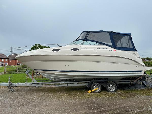 Sea Ray 240 Sundancer 2000 Sea Ray Sundancer 240 boat on trailer, parked outdoors, with blue canopy.
