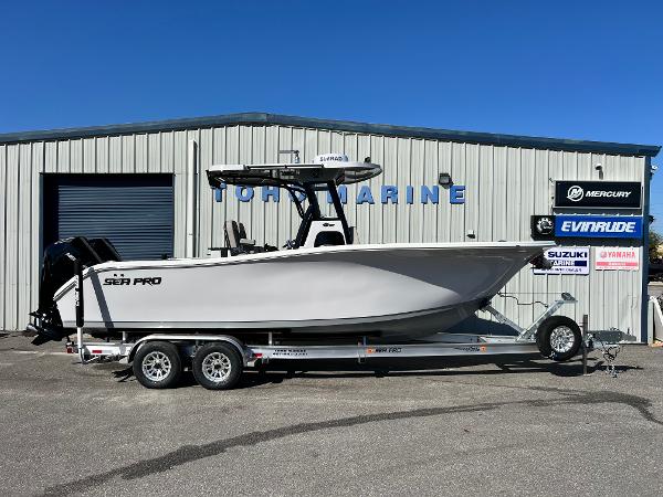 Sea Pro 262 DLX 2024 Sea Pro 262 DLX boat on a trailer outside a marine dealership.