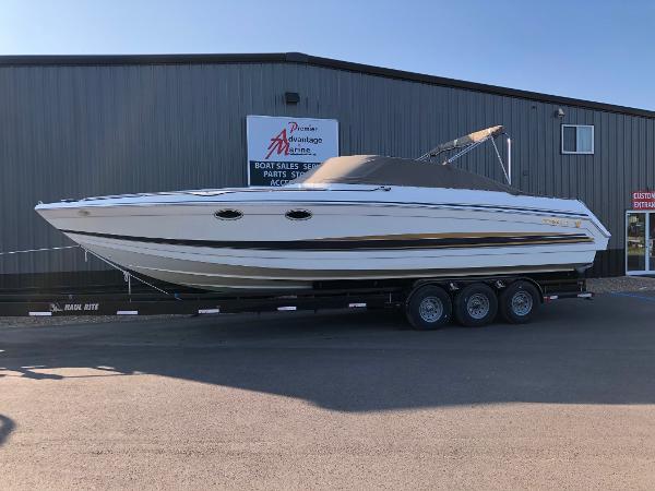 Formula 330 SS 2002 Formula 330 SS boat on trailer outside dealership building.
