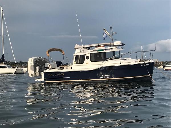 Ranger Tugs R-23 2016 Ranger Tugs R-23 boat on calm water, with other boats in the background.