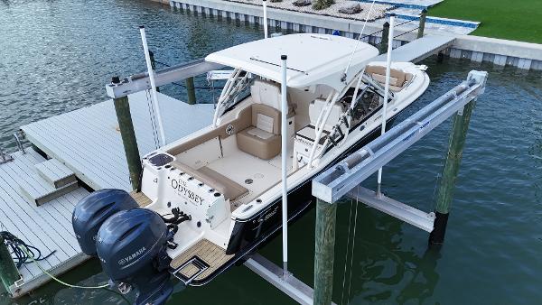 Scout 255 Dorado 2023 Scout 255 Dorado SEA KEEPER RIDE on lift, dual Yamaha engines, docked.