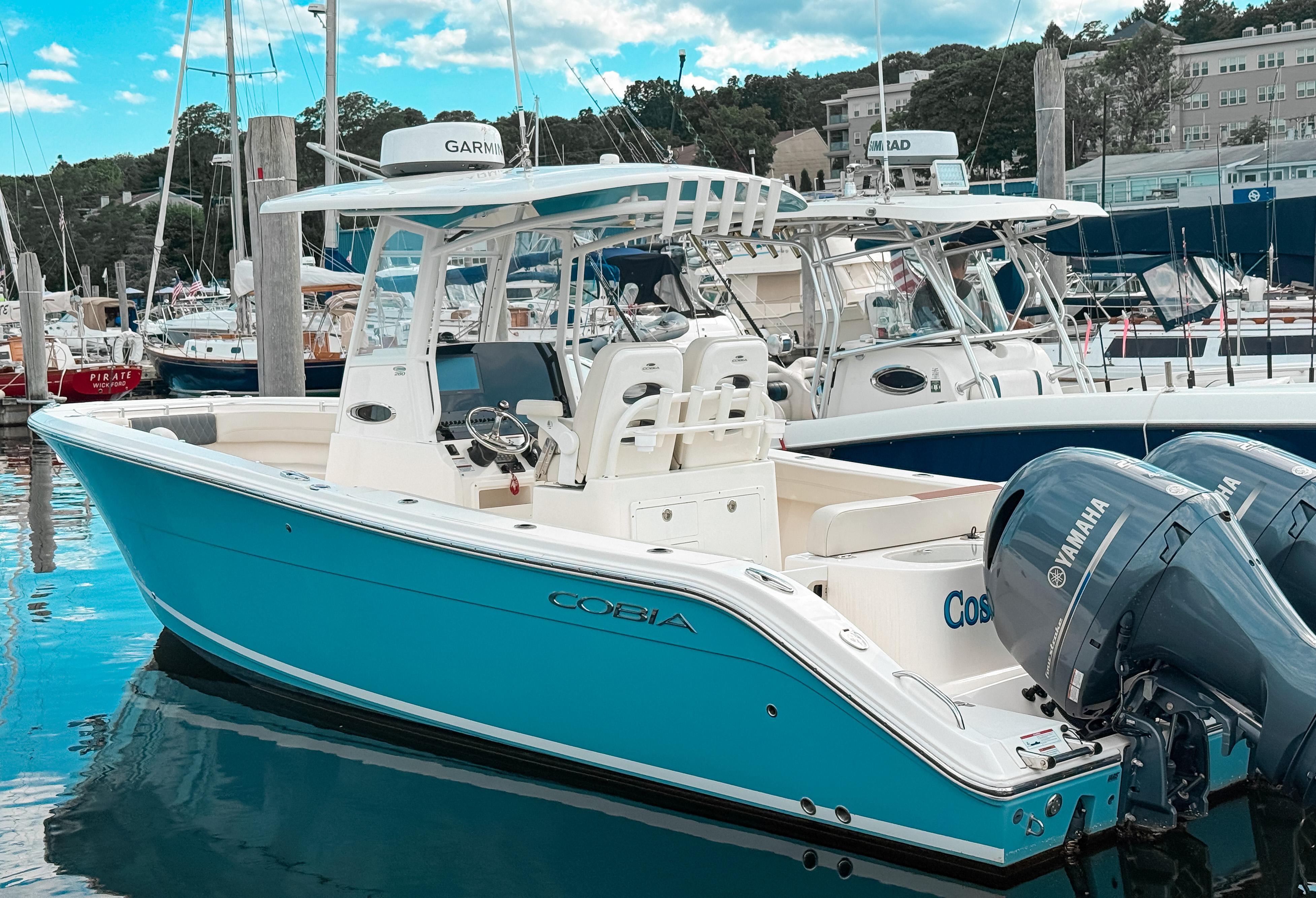 Cobia 280 Center Console 2023 Cobia 280 Center Console boat docked with Yamaha engines.