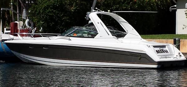 Formula 330 Ss 2004 Formula 330 SS boat docked on a calm waterway.