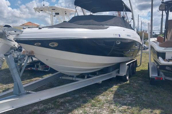 Rinker 296 Captiva Bowrider 2009 Rinker 296 Captiva Bowrider on trailer, black and white, parked outdoors.