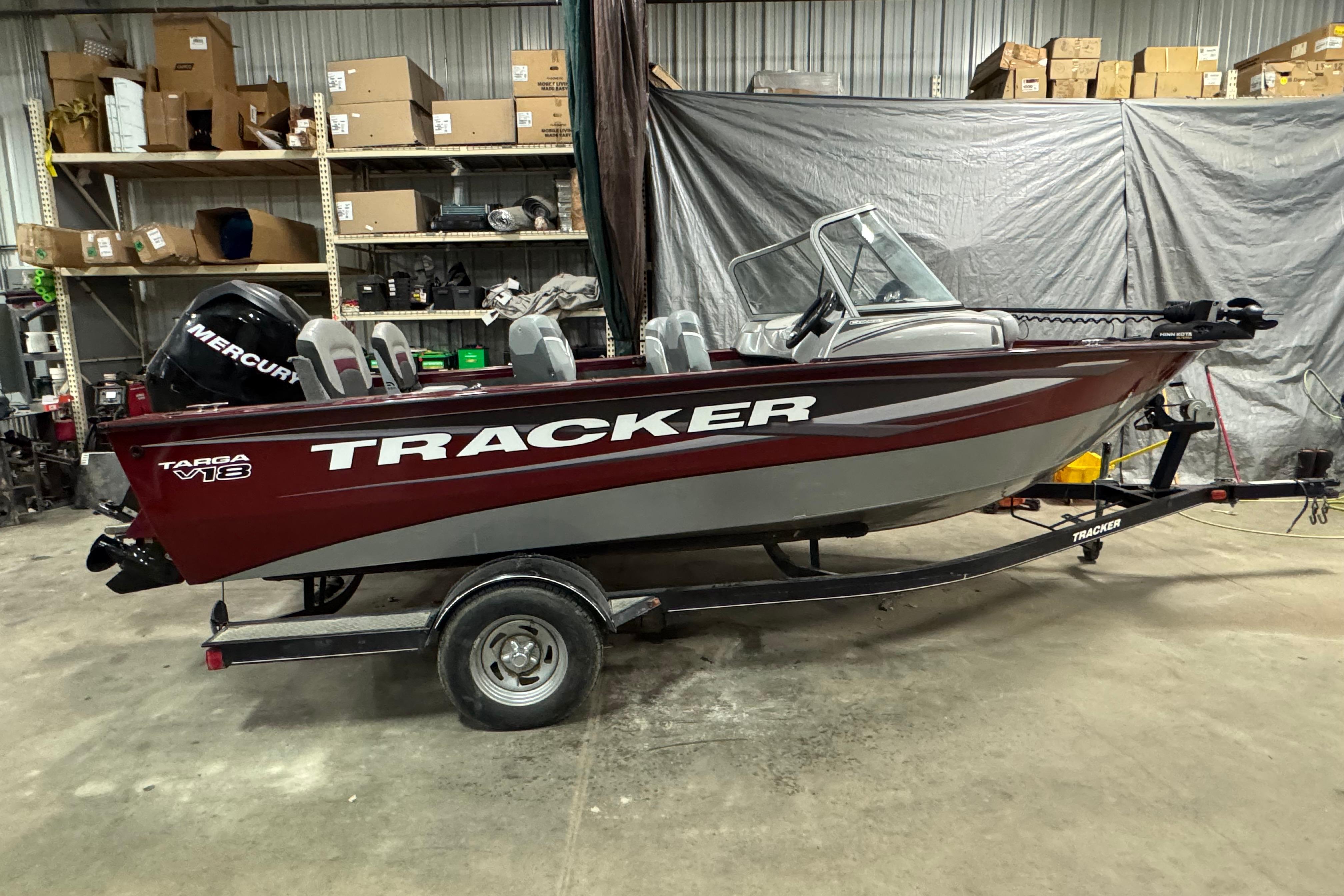 Tracker Targa V-18 Combo 2014 Tracker Targa V-18 Combo boat in a garage, red and silver design.
