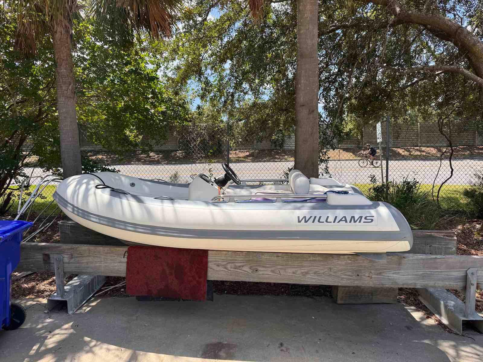 Williams Jet Tenders Sportjet 345 2018 Williams Jet Tenders Sportjet 345 on wooden stand, surrounded by trees.
