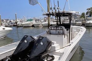 Sea Pro 262 DXL 2024 Sea Pro 262 DXL boat docked at marina with twin engines and fishing rods.