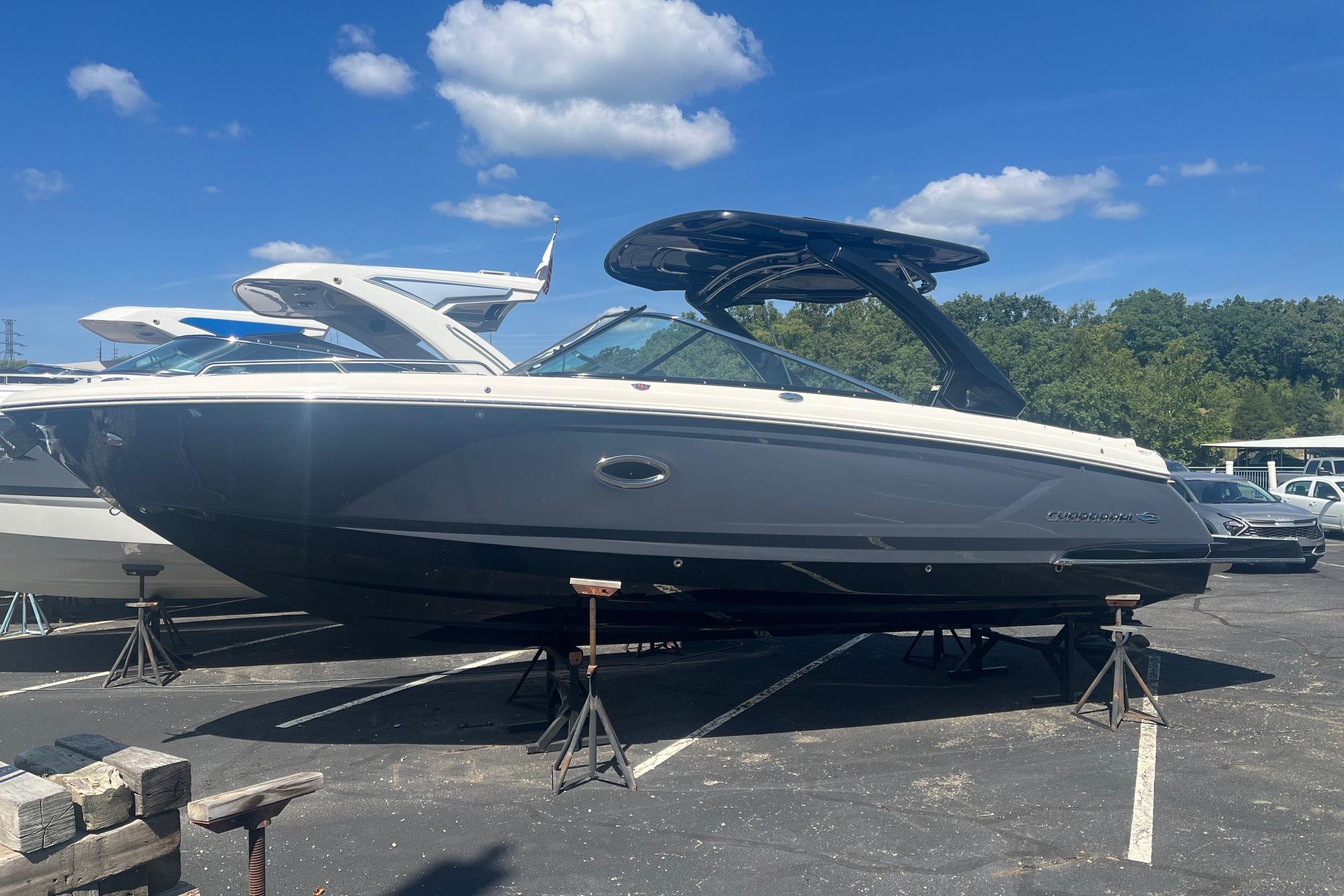 Chaparral 307 SSX 2022 Chaparral 307 SSX boat on stands under a clear blue sky.
