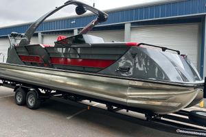 Trifecta Sport RF9 DC 2025 Trifecta Sport RF9 DC pontoon boat on trailer, sleek design, gray and red accents.