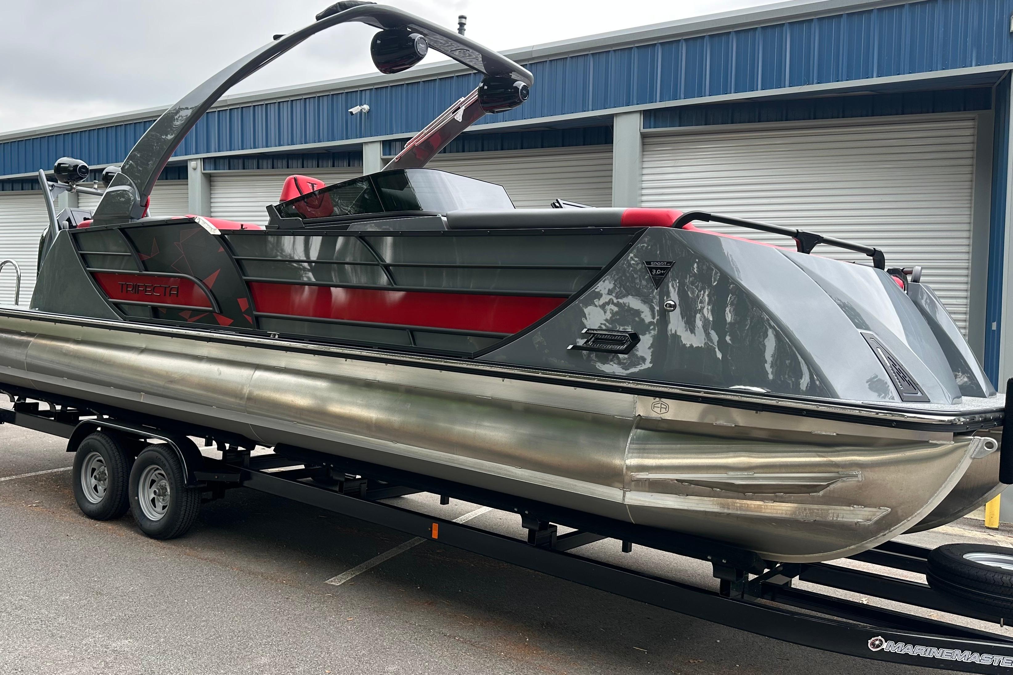 Trifecta Sport RF9 DC 2025 Trifecta Sport RF9 DC pontoon boat on trailer, sleek design, gray and red accents.
