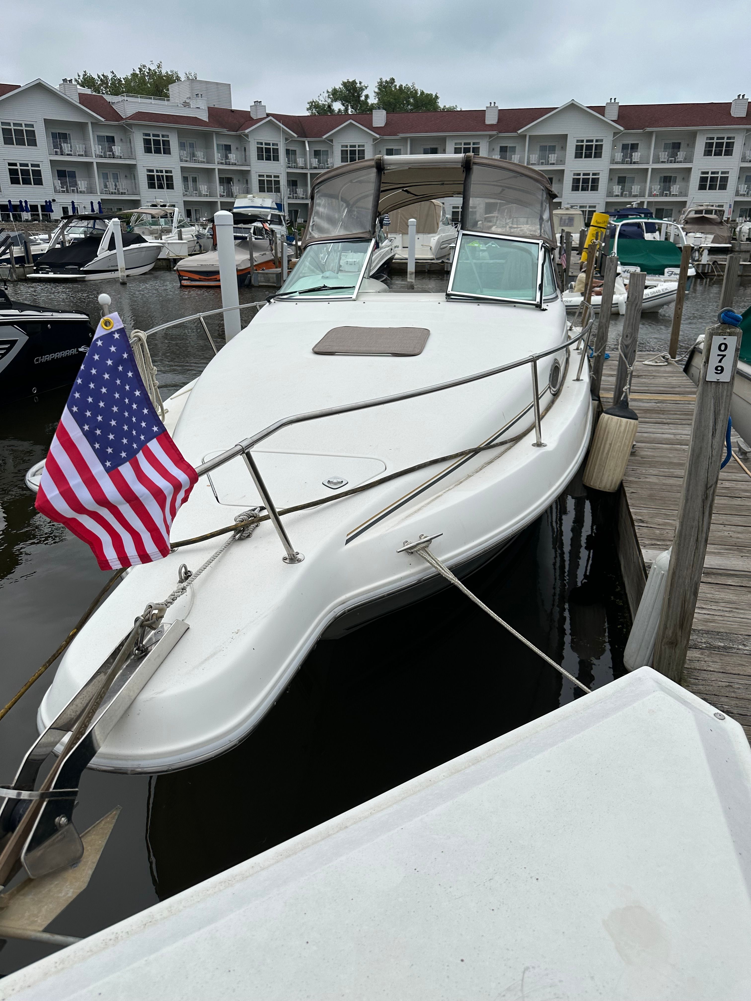 Sea Ray Sundancer 1996 Sea Ray Sundancer docked with American flag, marina background.