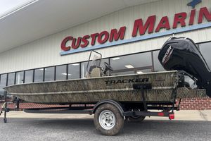 Tracker Grizzly 1860 CC 2026 Tracker Grizzly 1860 CC boat on trailer outside Custom Marine store.