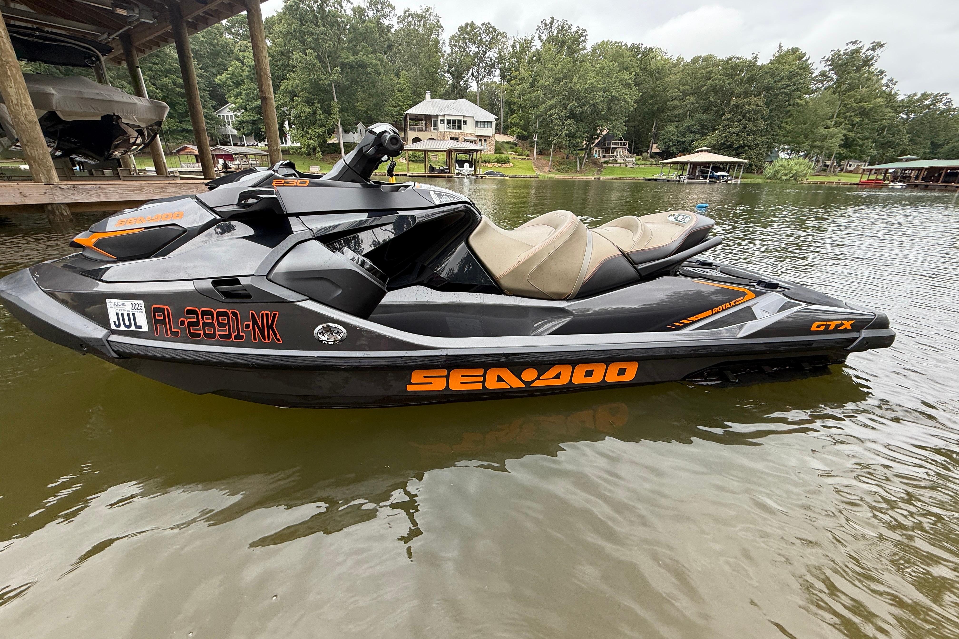 Sea-Doo GTX 230 2021 Sea-Doo GTX 230 jet ski on a calm lake near a dock.