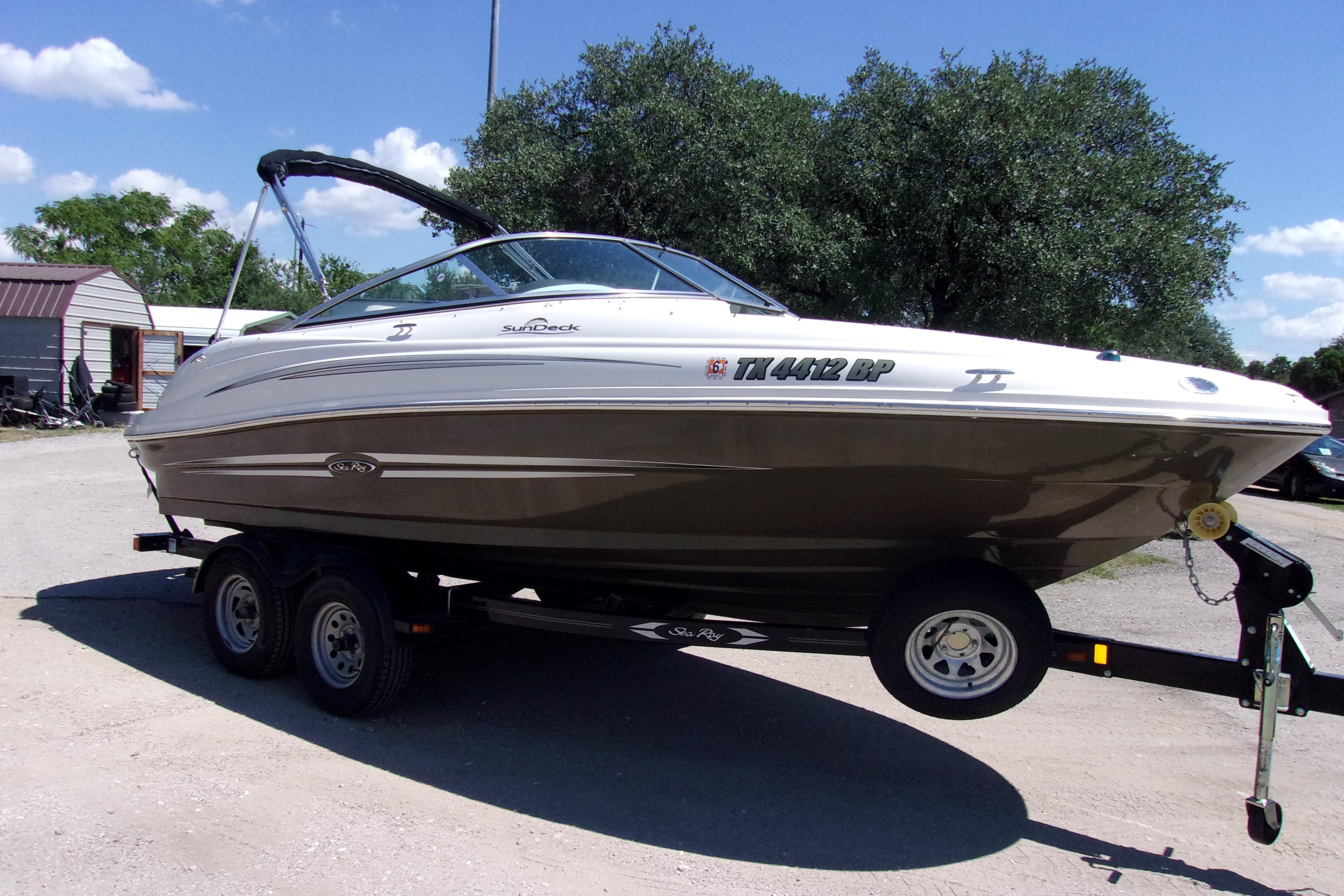 Sea Ray 200 Sundeck 2012 Sea Ray 200 Sundeck boat on trailer, parked outdoors under clear sky.