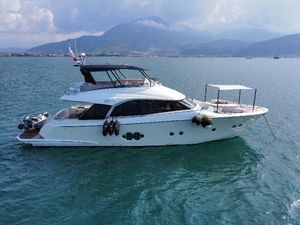 Monte Carlo Yachts MCY 65 2018 Monte Carlo Yachts MCY 65 cruising on calm waters with scenic mountain backdrop.