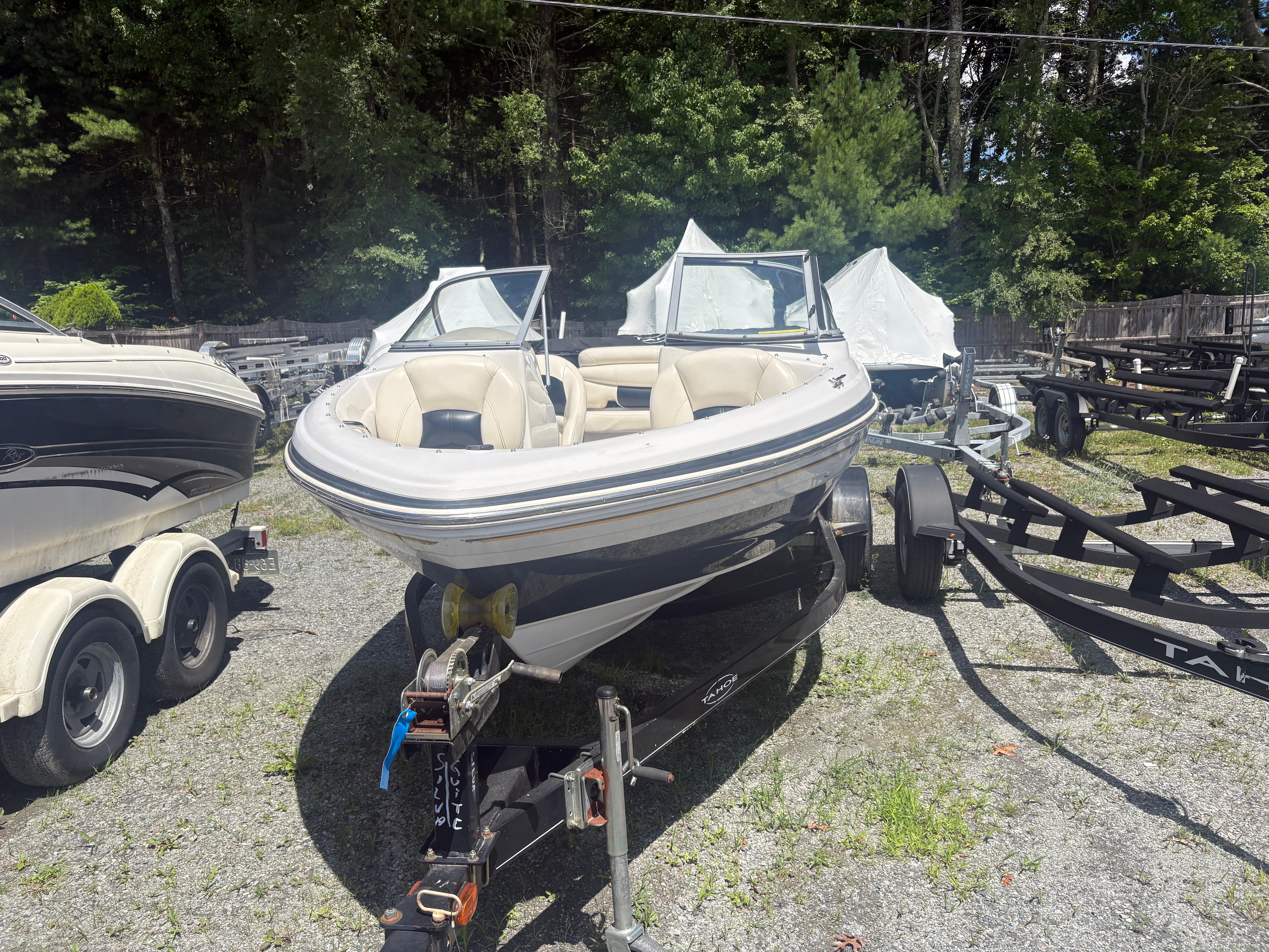 Tahoe Q5i 2012 Tahoe Q5i boat on trailer in outdoor storage area.