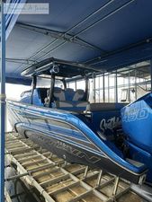 Fountain 43 NX 2023 Fountain 43 NX boat in blue, docked under a canopy.