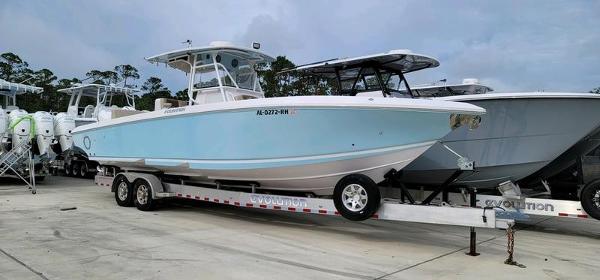 Fountain 34 Cc 2018 Fountain 34 CC boat on trailer, light blue hull, parked outdoors.