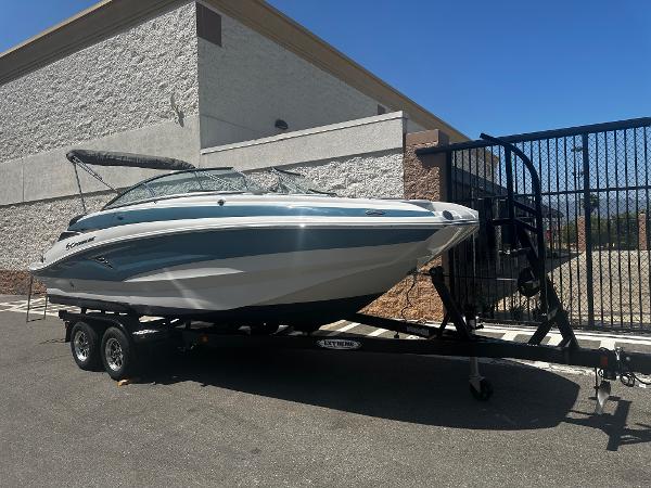 Crownline Eclipse E235 XS 2022 Crownline Eclipse E235 XS boat on a trailer near a building.