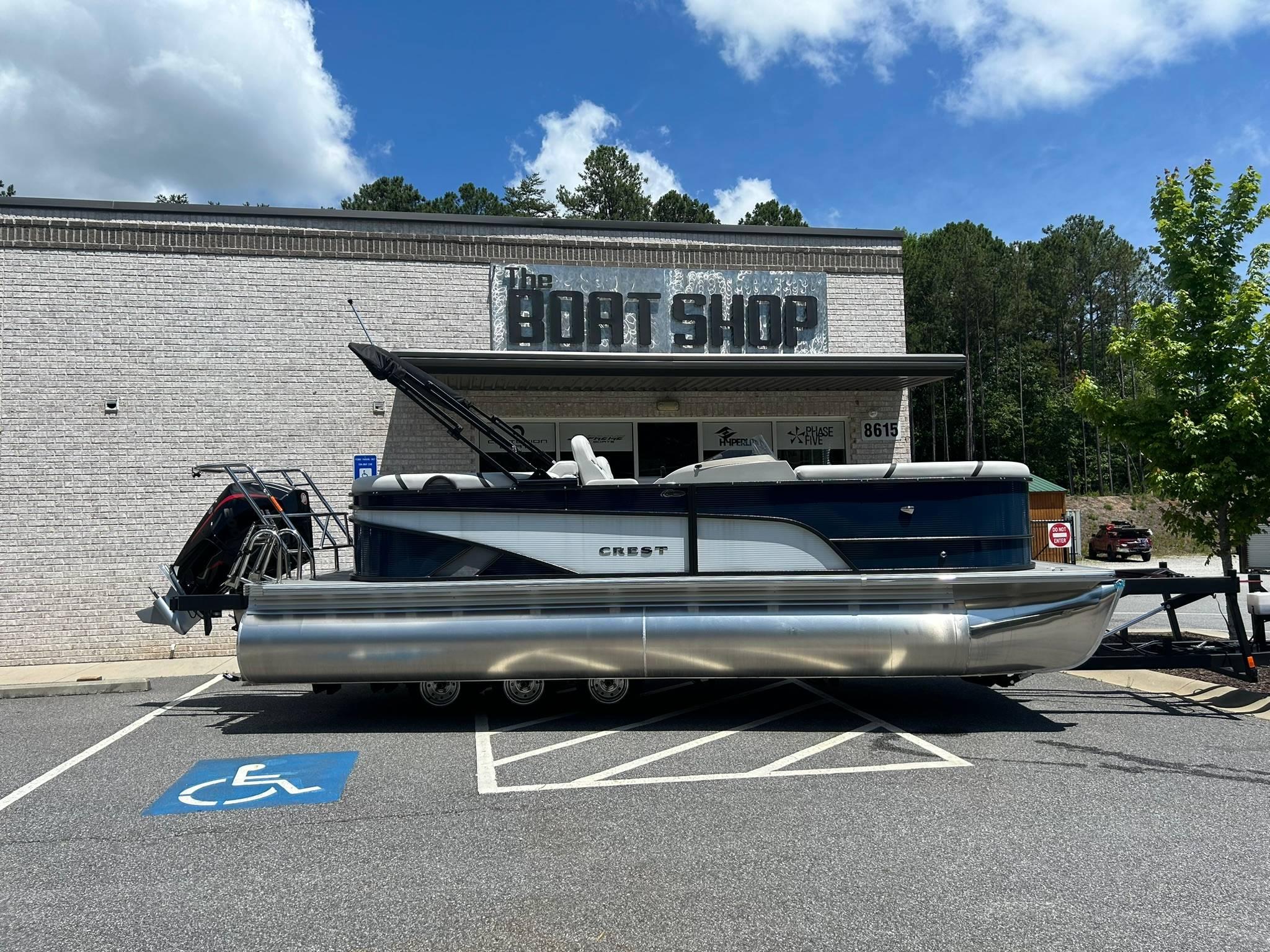 Crest Classic Platinum 220 SLC 2024 Crest Classic Platinum 220 SLC pontoon boat outside The Boat Shop.