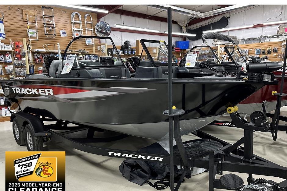 Tracker Targa V-18 Combo 2025 Tracker Targa V-18 Combo boat on display in a showroom with clearance sale sign.