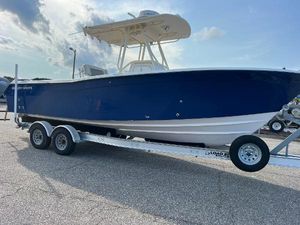 Grady-White Chase 273 2002 Grady-White Chase 273 boat on trailer, blue hull, parked outdoors under cloudy sky.