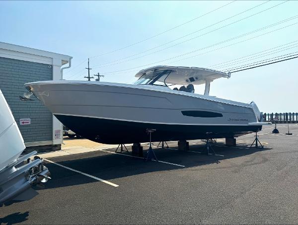 Regal 38 SAV 2026 Regal 38 SAV boat on stands in a parking lot, side view.