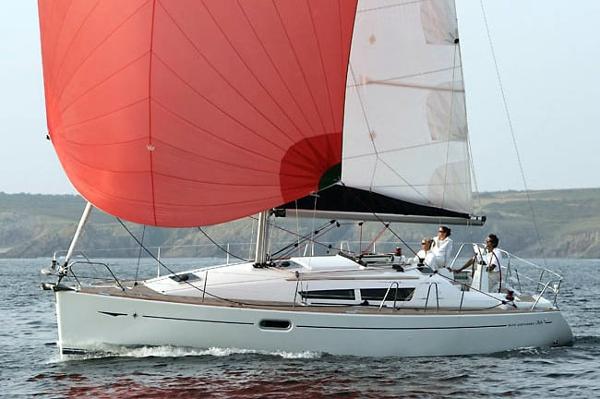 Jeanneau Sun Odyssey 36i 2010 Jeanneau Sun Odyssey 36i sailing with red spinnaker on open water.