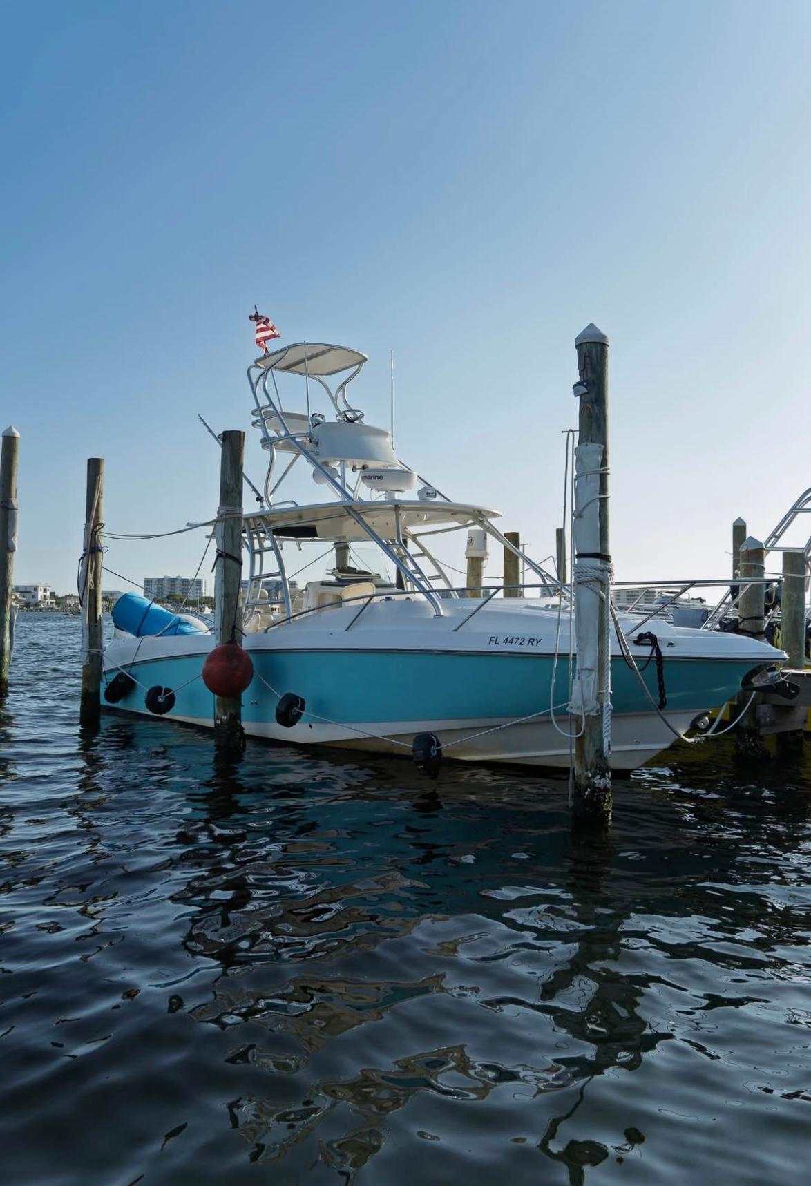 Boston Whaler 320 Outrage Cuddy Cabin 2006 Boston Whaler 320 Outrage Cuddy Cabin docked in a marina, clear sky background.
