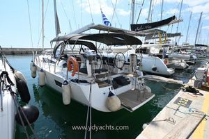 Jeanneau 54 2019 Jeanneau 54 yacht docked in marina, featuring spacious deck and modern design.