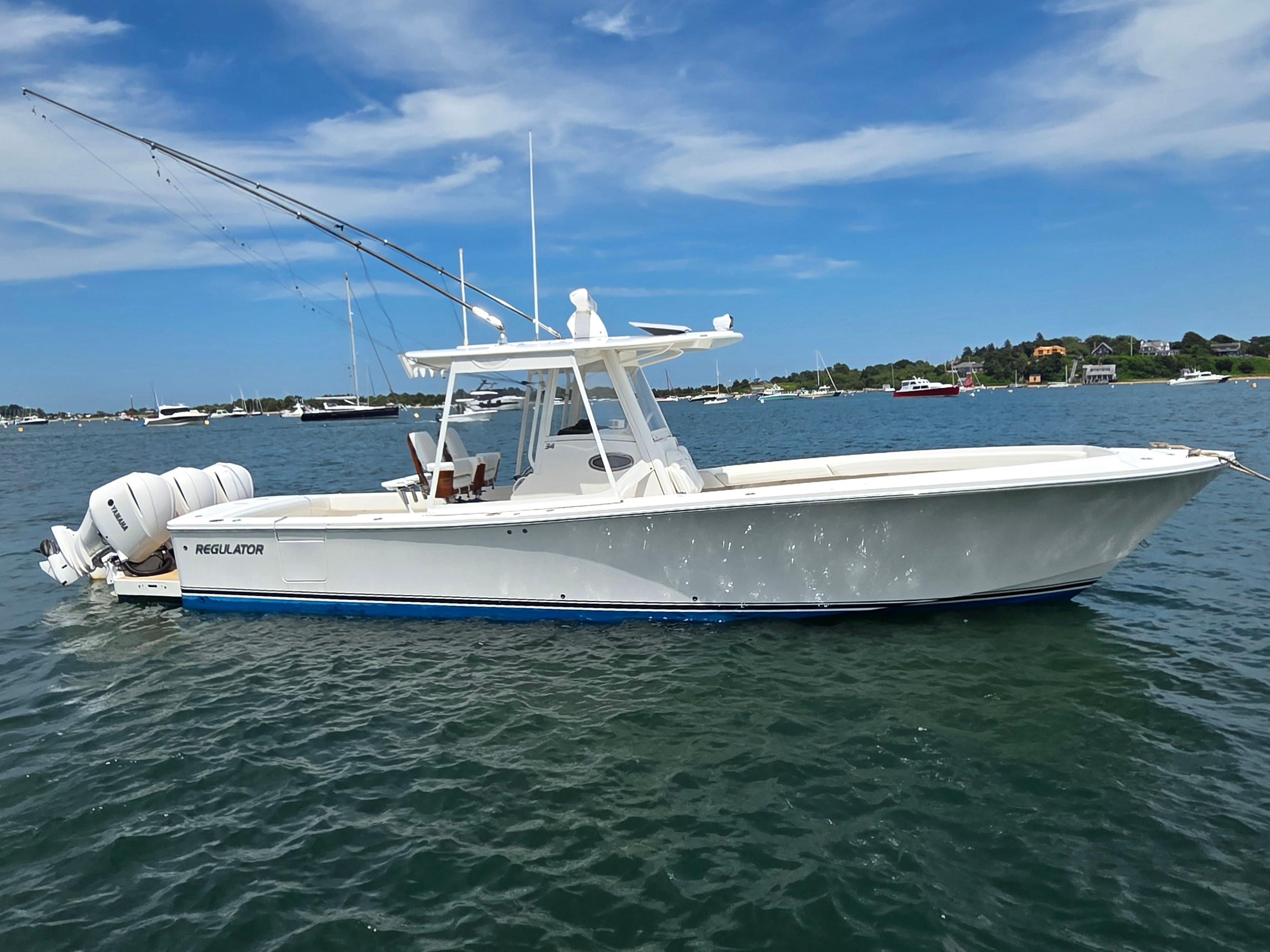 Regulator 34 Center Console 2020 Regulator 34 Center Console boat on calm water under blue sky.