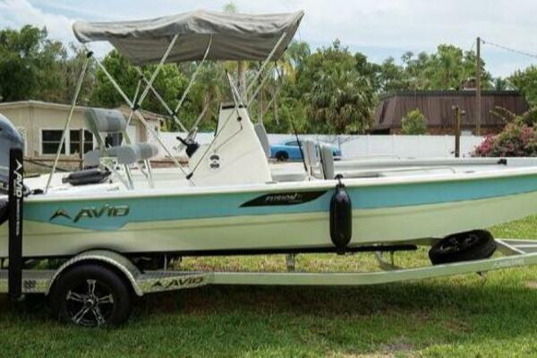 Avid 21 Fusion Avid 21 Fusion 2022 boat on trailer with canopy, parked on grass.